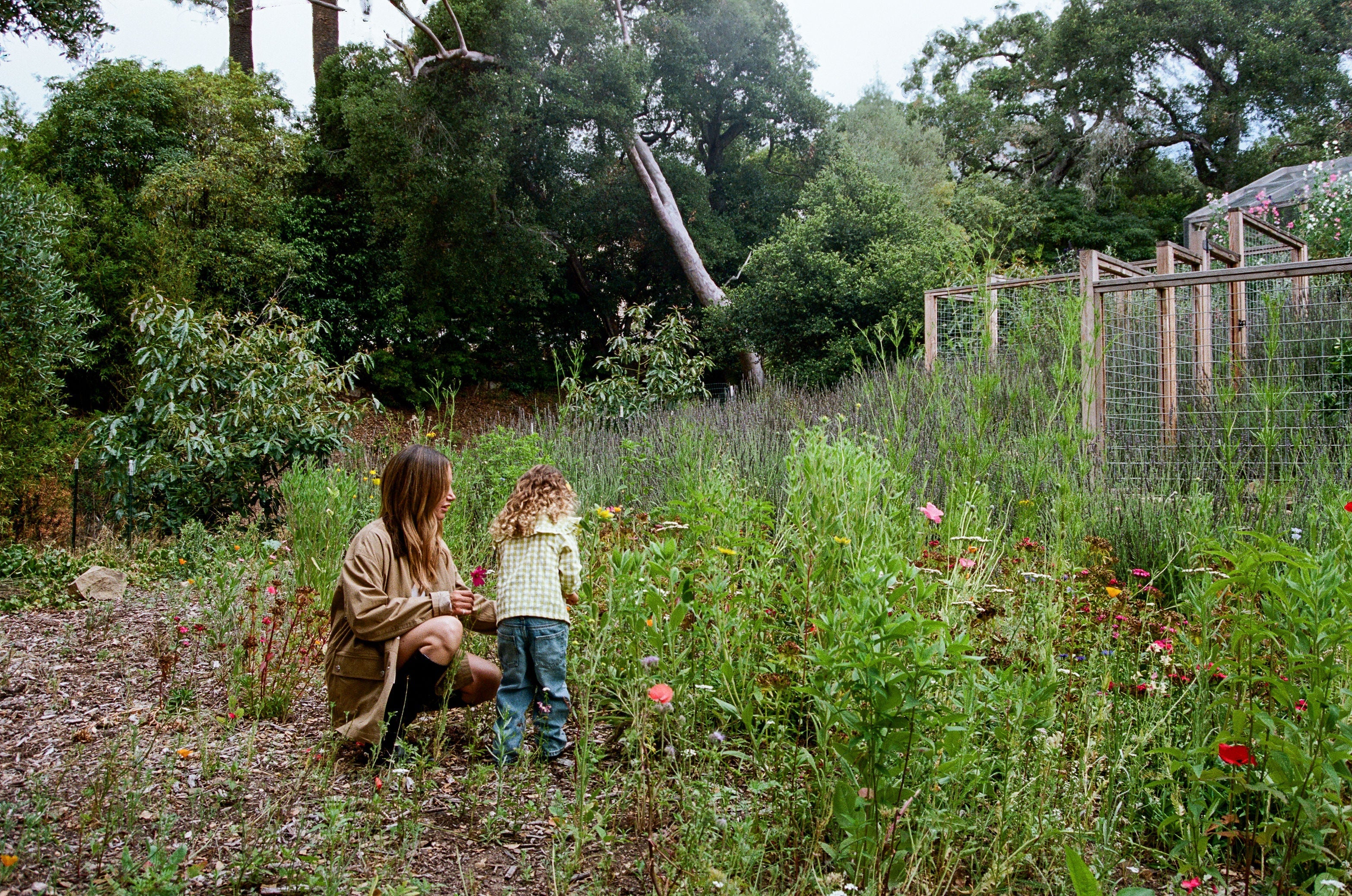 Ashley and daughter Jupiter smelling flowers